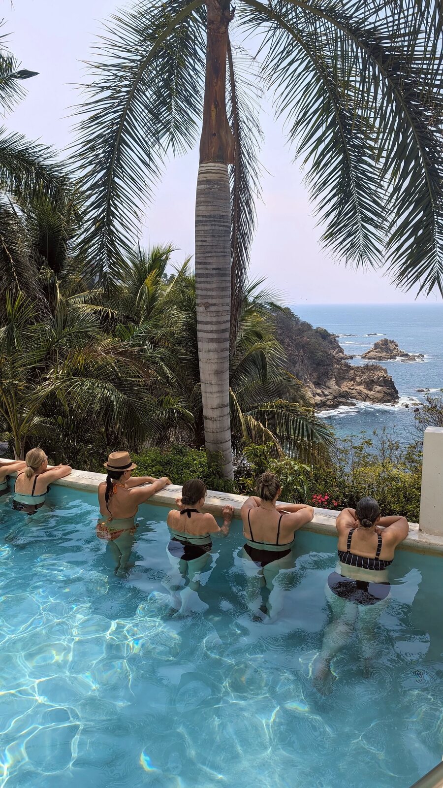Looking out over the ocean from a quiet pool — a moment from one of Marisa's retreats.